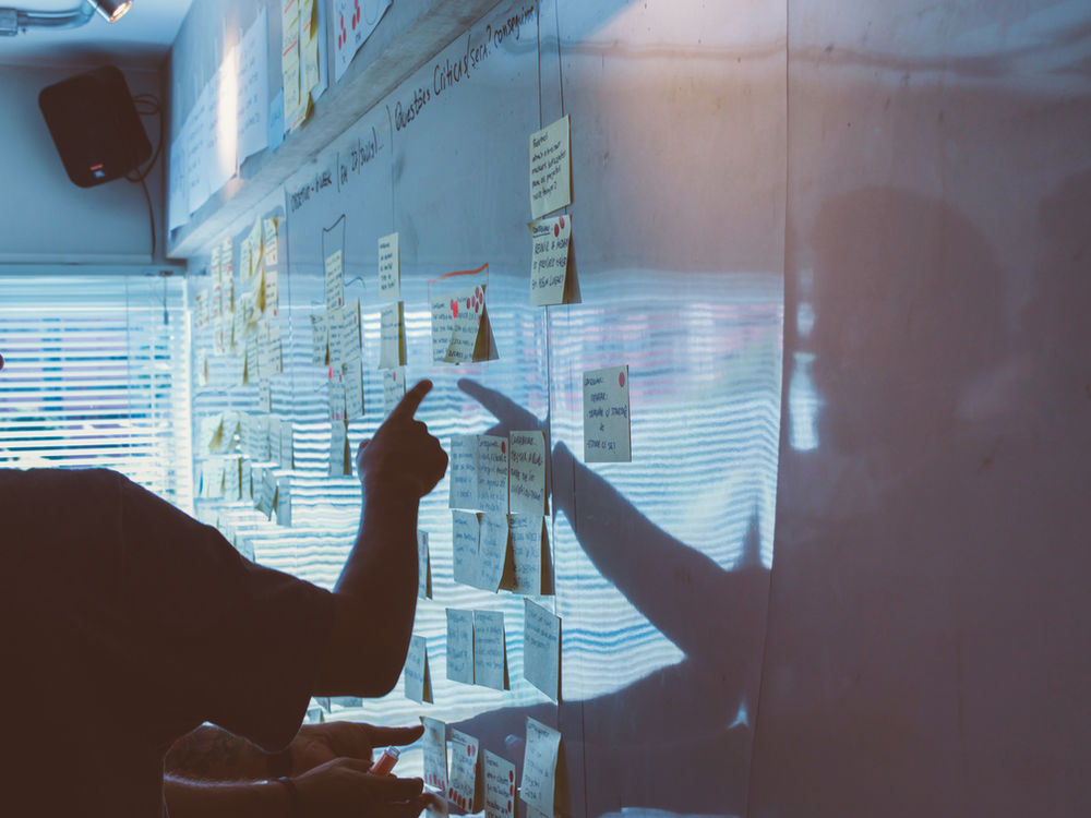 Team mapping out market research on a whiteboard